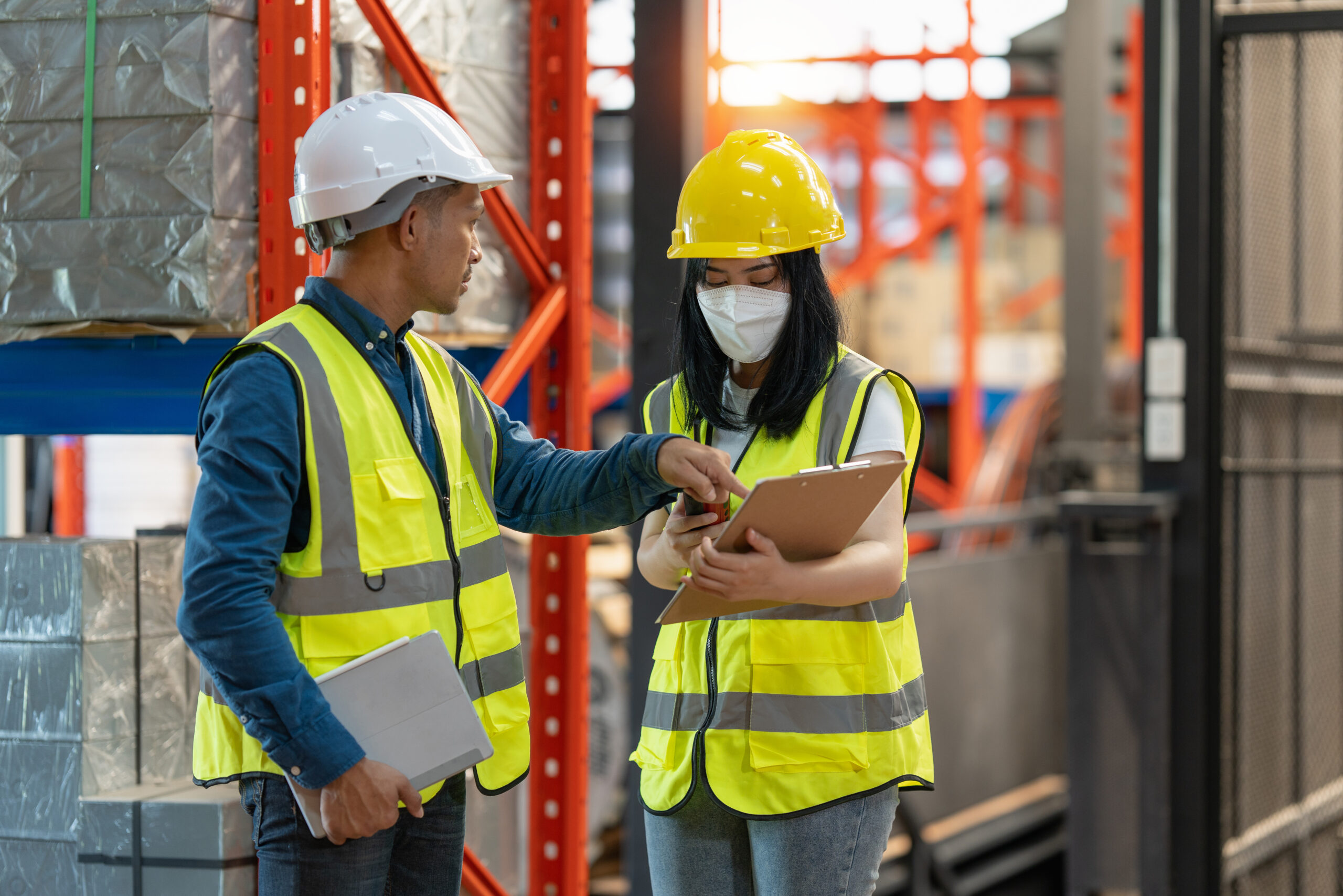 Working at warehouse. Male warehouse worker checking in storage department. Employee organizing goods distribution to the market